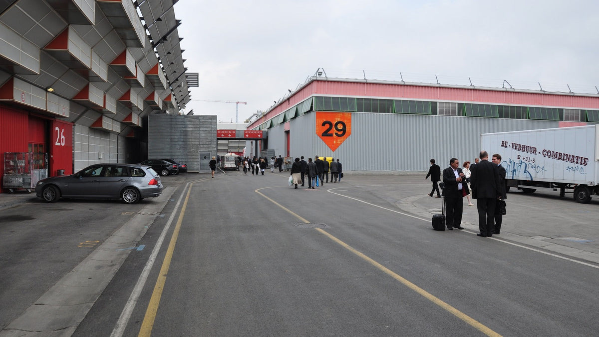 Visitors walking between numbered exhibition halls at BolognaFiere in Bologna.