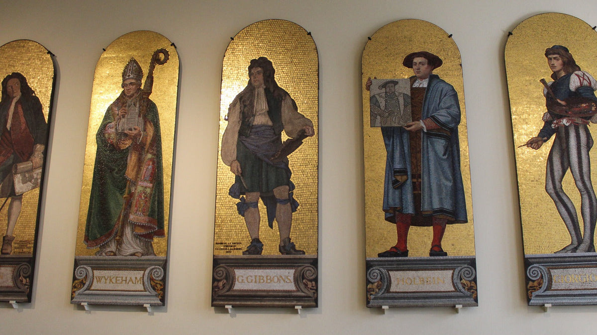 Long row of nineteenth-century ceramic mosaic portraits installed between columns at the Victoria and Albert Museum.