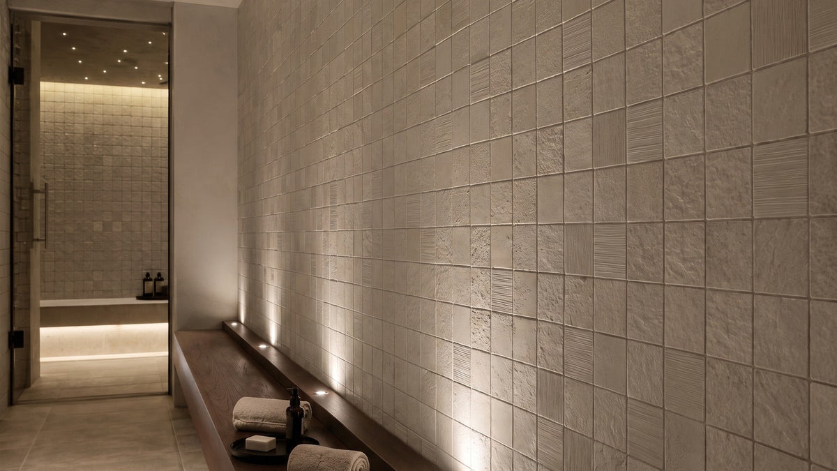 Appiani Pietre 10-by-10-centimeter modules forming a textured architectural surface in pastel tones.