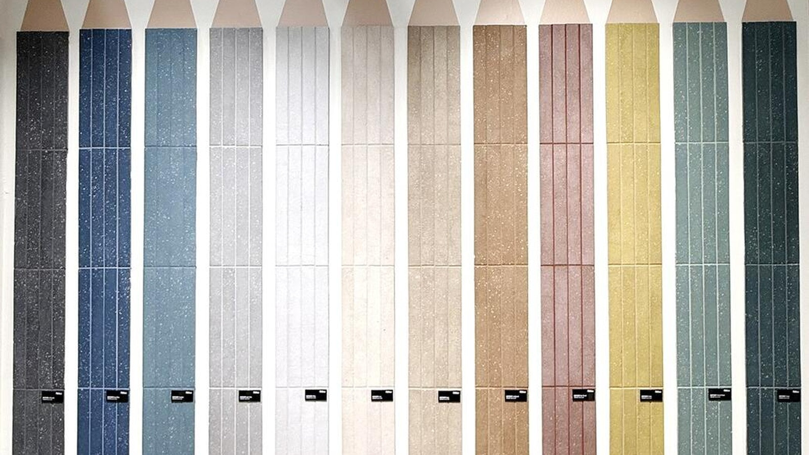 Wall of colored tile samples photographed at Cersaie 2025