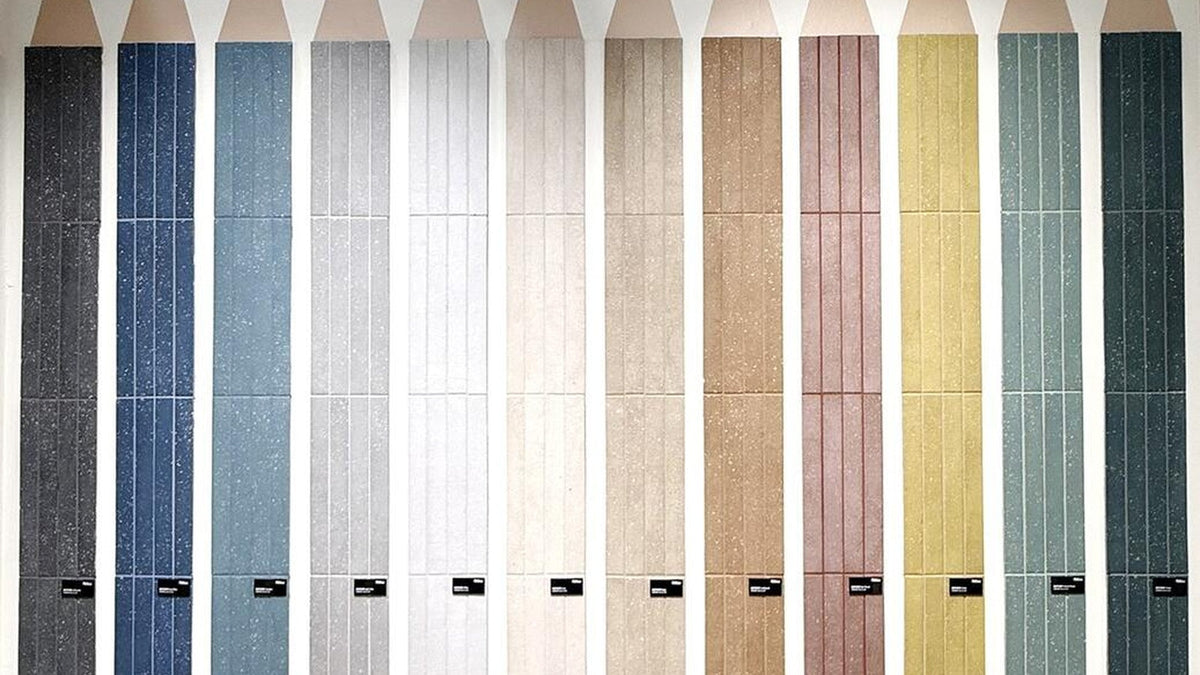 Wall of colored tile samples photographed at Cersaie 2025