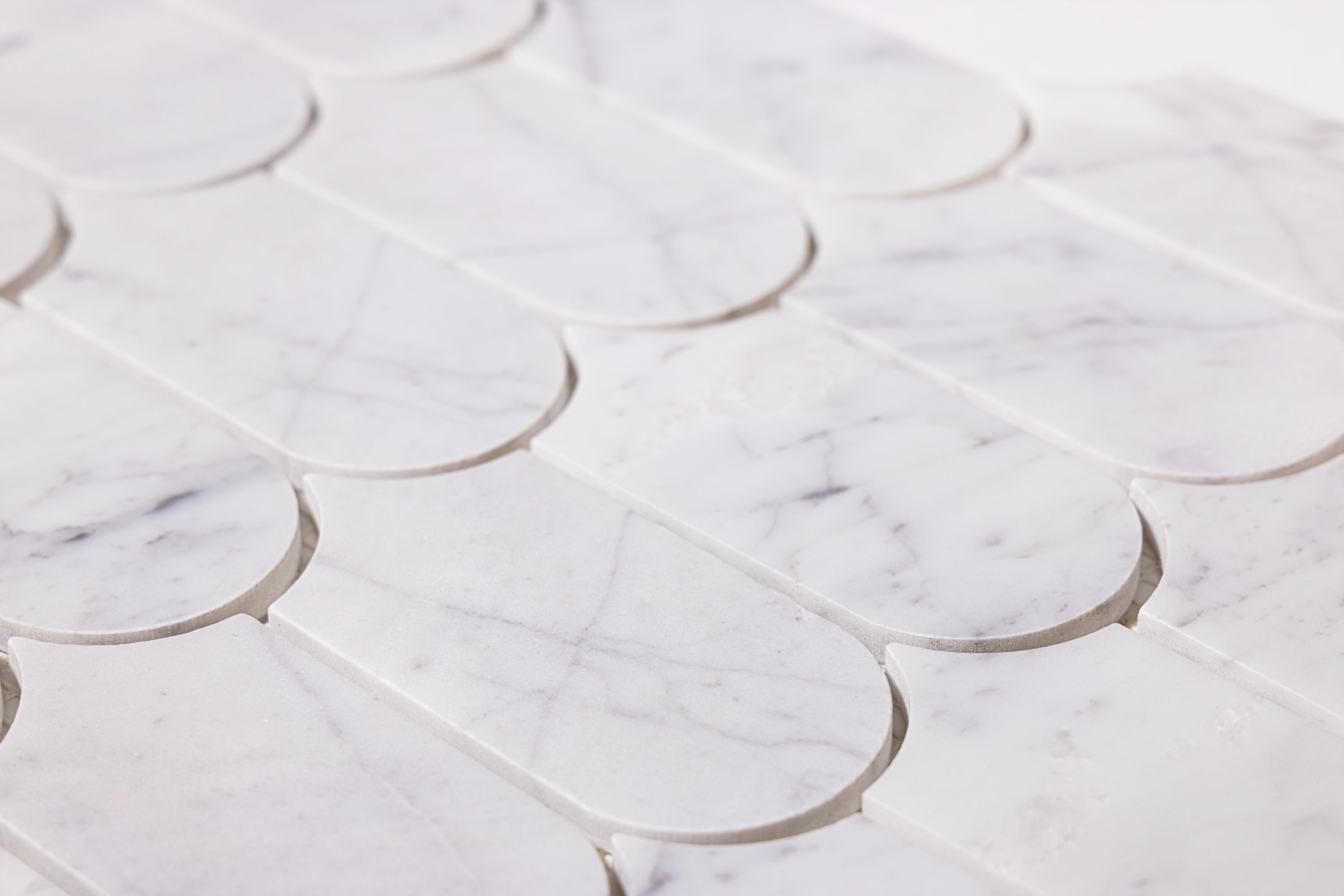 Close-up of Aurialle Carrara marble scallop mosaic tile