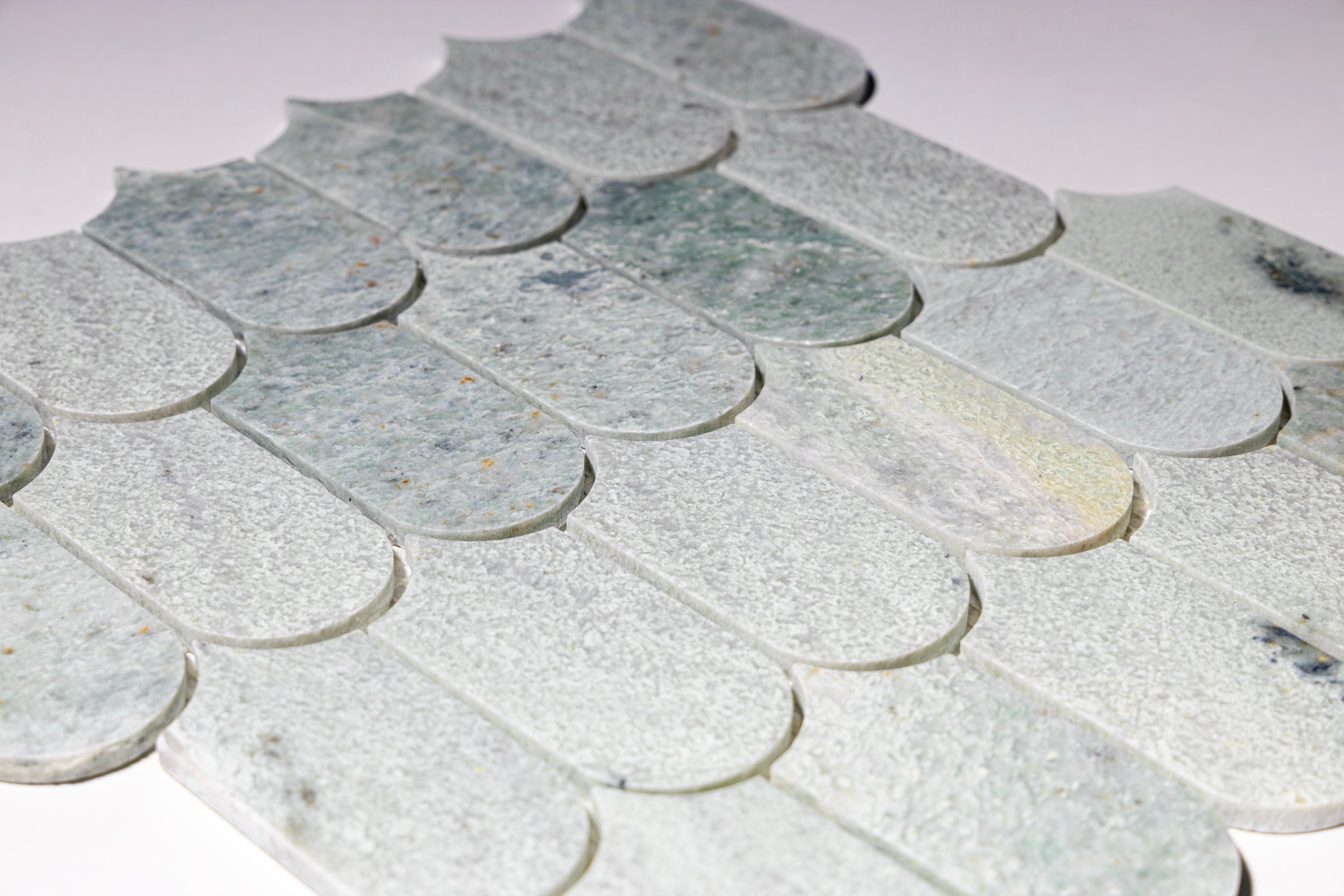Close-up of Borealle green marble scallop mosaic tile