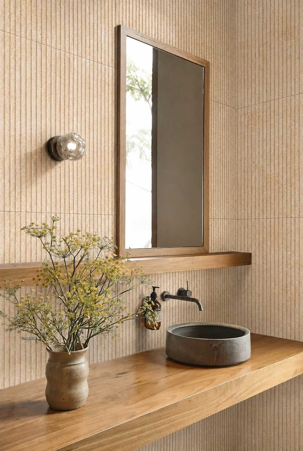 Ceres fluted travertine tile installed in a bathroom with wood vanity and vessel sink