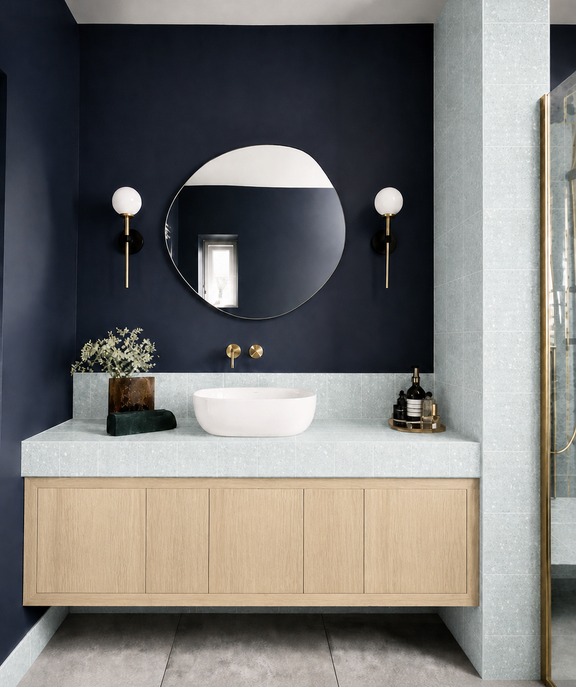 Dorothy terrazzo tile installed in a navy bathroom with white oak vanity