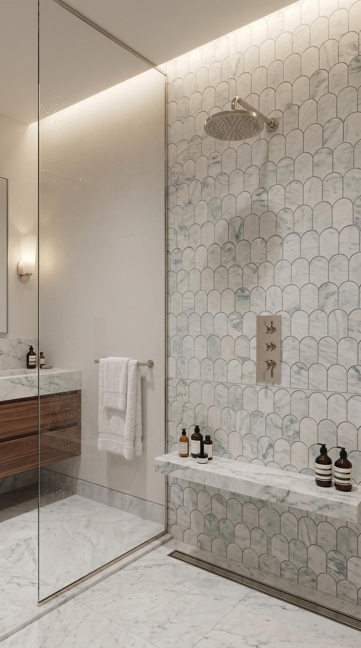 Borealle arch mosaic lining a walk-in shower wall