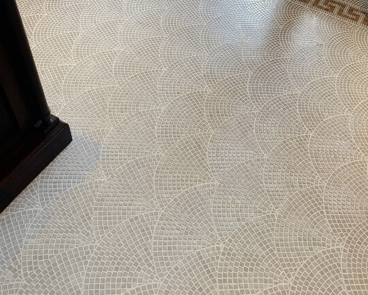 Pallazzo pale marble mosaic floor with circular geometry and a contrasting border.