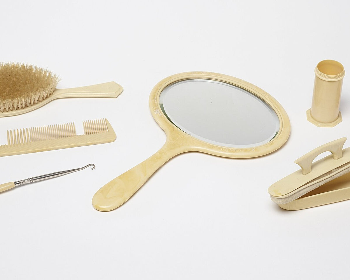 Pyralin celluloid vanity objects including mirror, brush, and comb