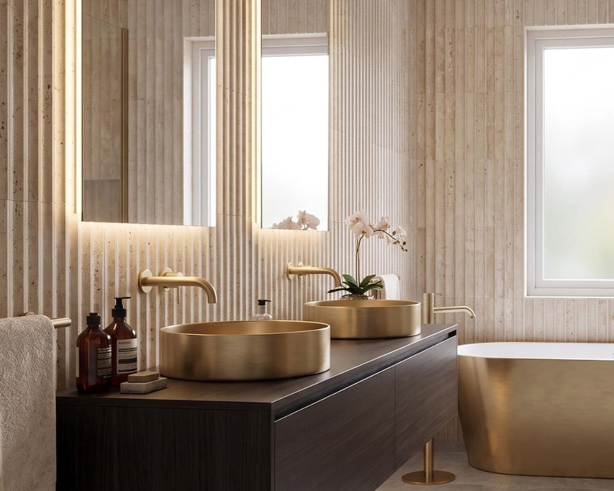 Ceres fluted travertine tile in a bathroom with brass fixtures