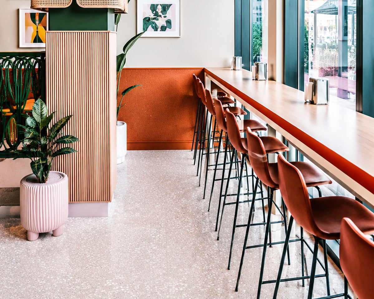 Toto pink terrazzo tile installed in a bright cafe interior