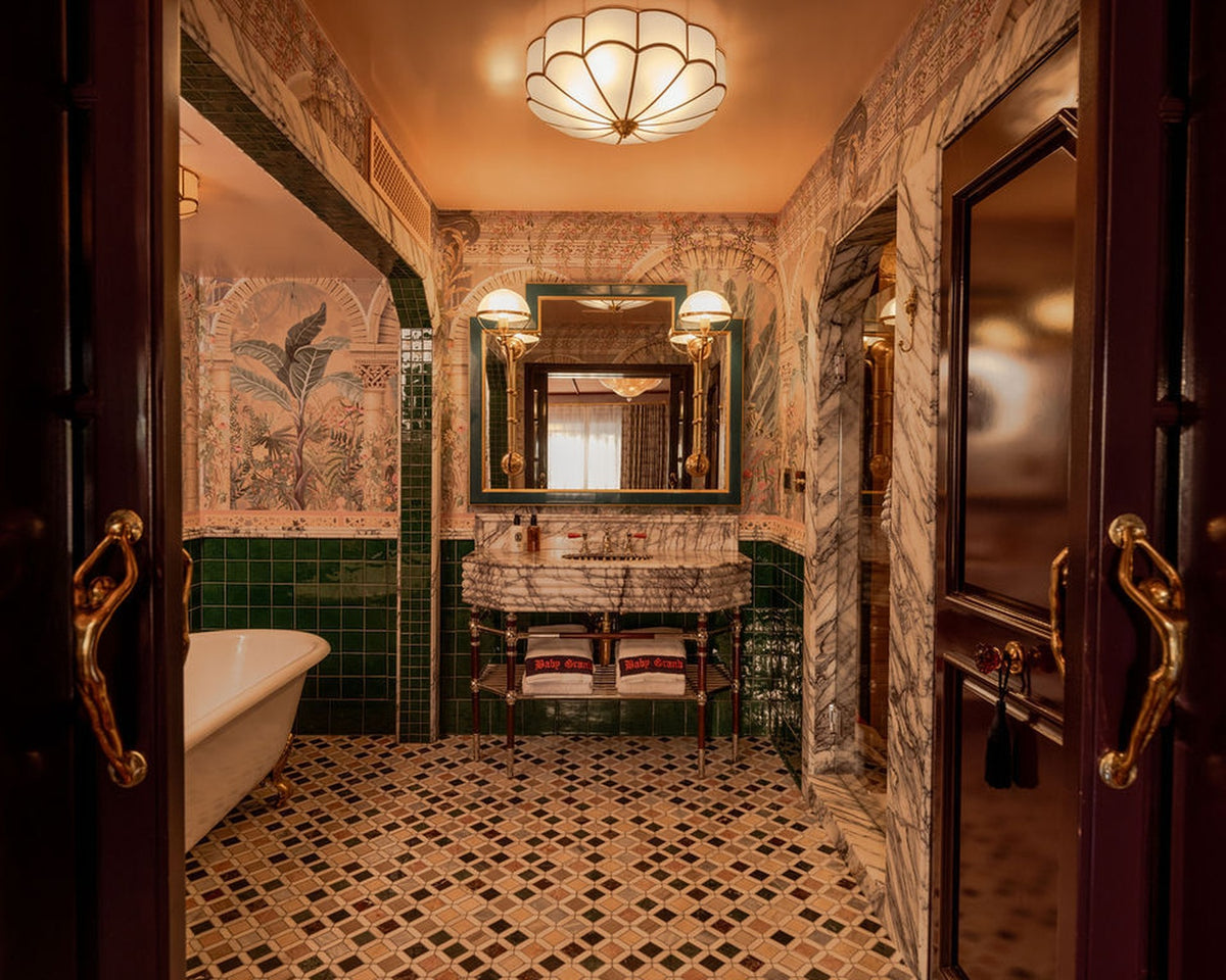 Marble and mosaic bathroom with a clawfoot tub at The Baby Grand