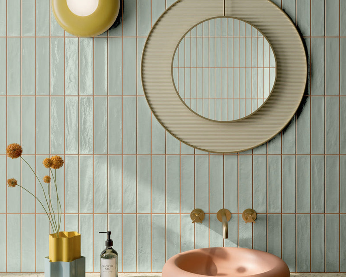 Ghiaccioli tile in pistachio and peach tones with a circular mirror