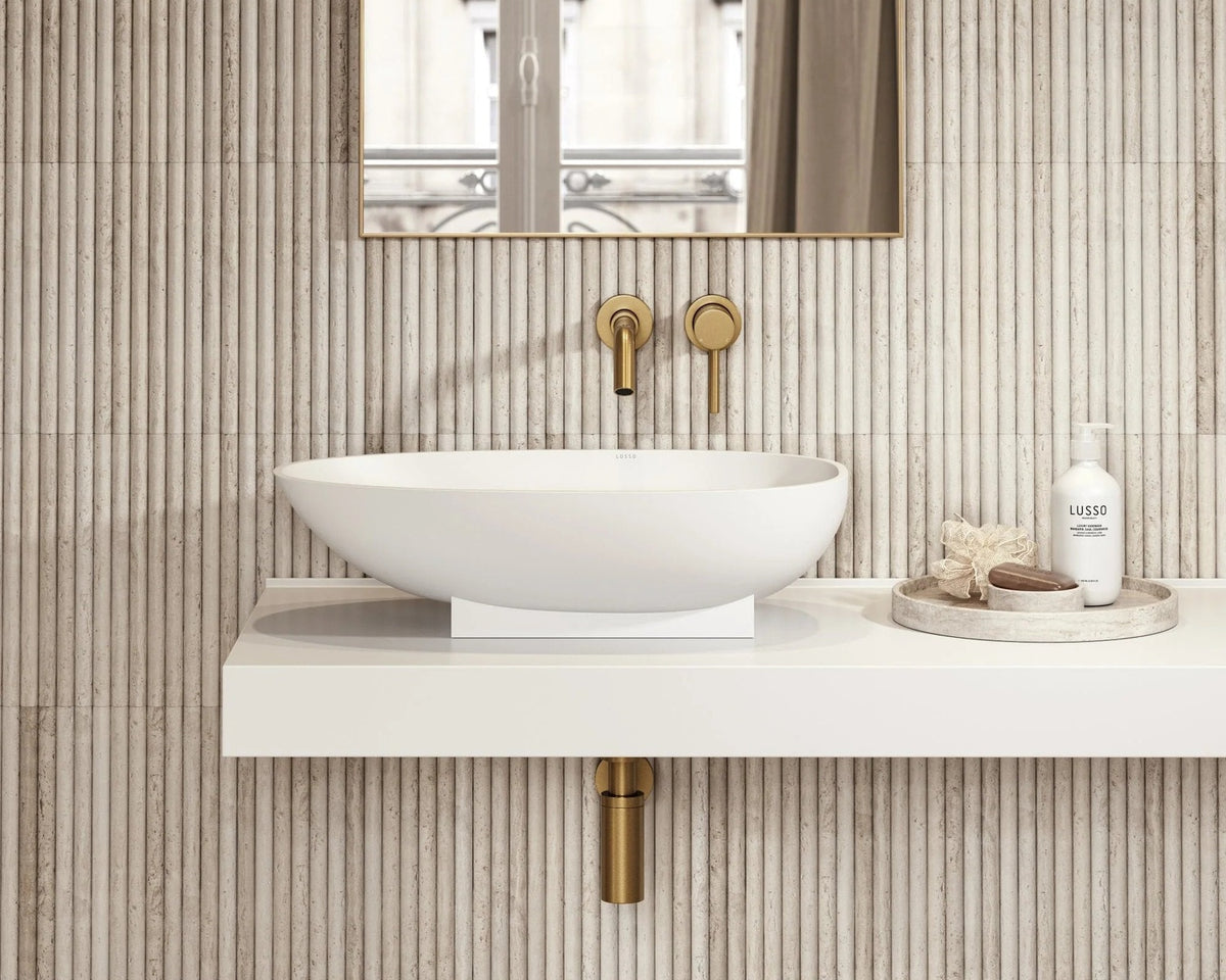 HAUS Nagisa travertine mosaic installed behind a bathroom vanity