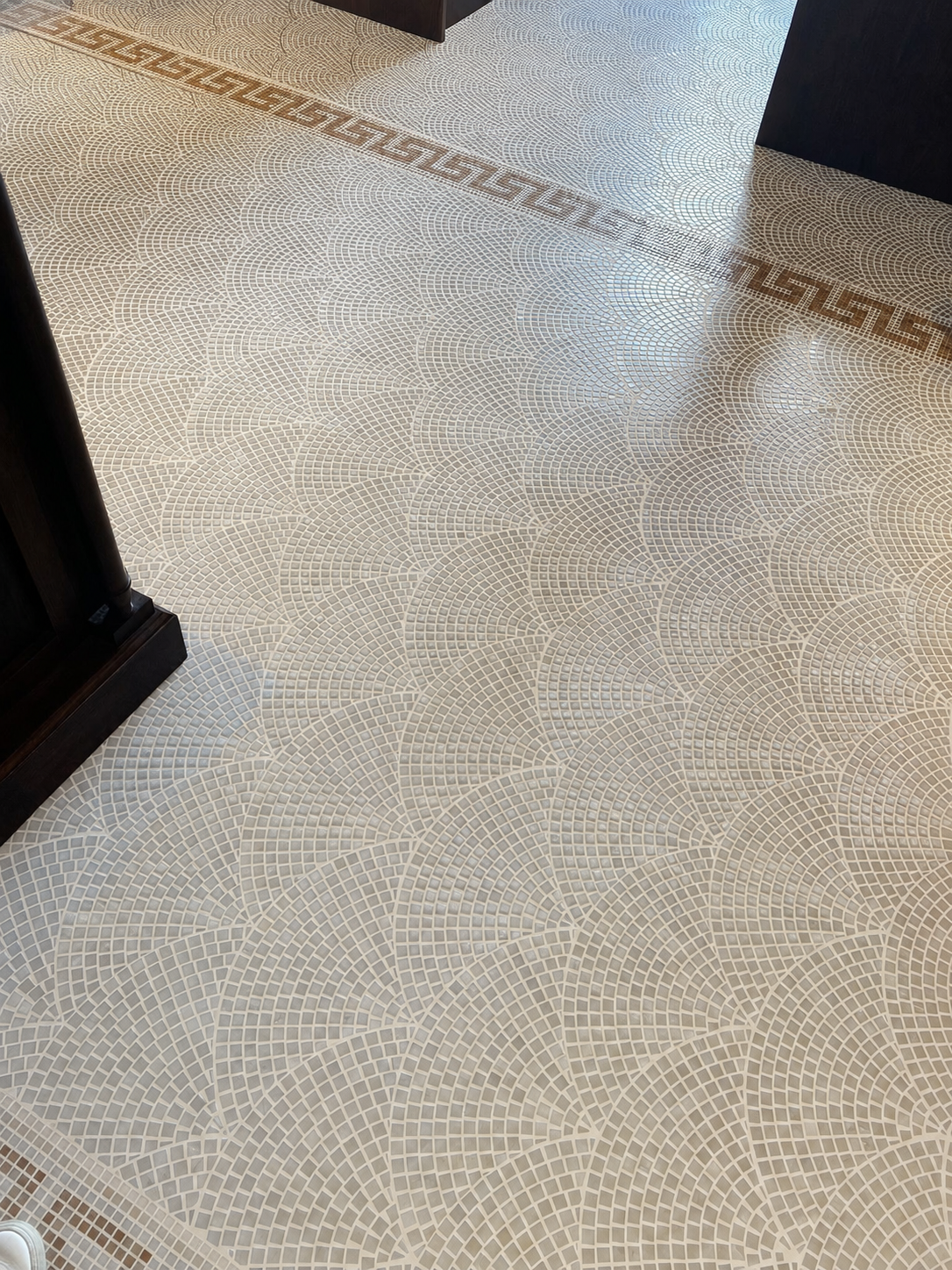Pallazzo marble mosaic floor installation with warm white grout